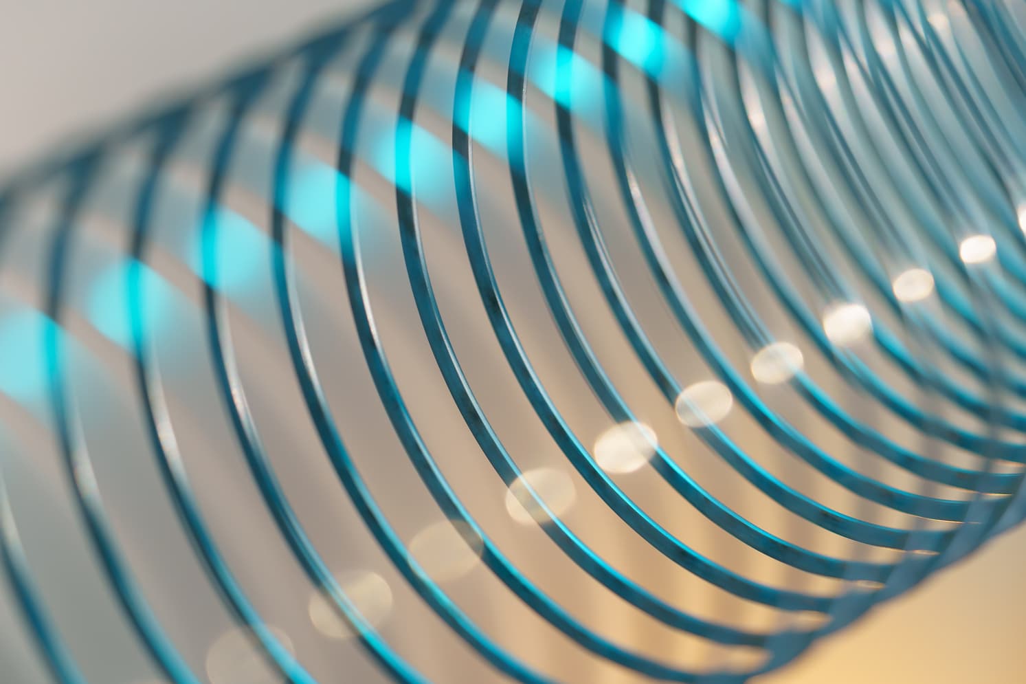 closeup of coiled metal spring with sufficiently high strength and elastic properties in neon light