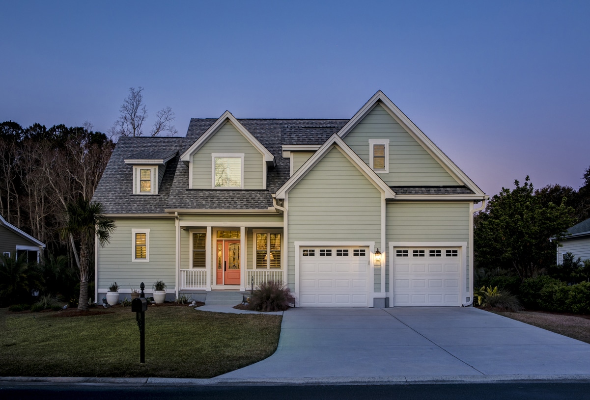 front elevation of beautiful home lit up at twilight.