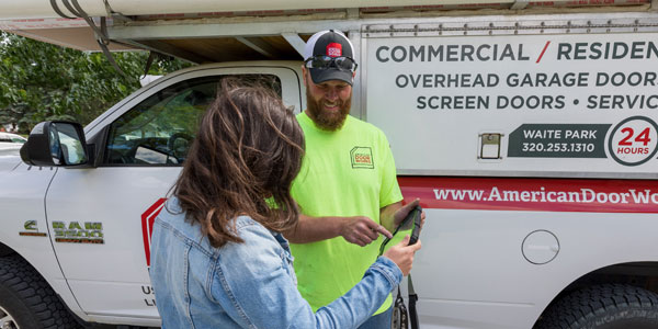 Technician talking to customer at home