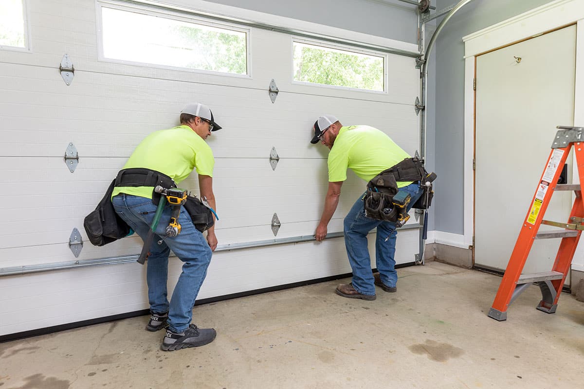 Technicians providing service on residential garage door