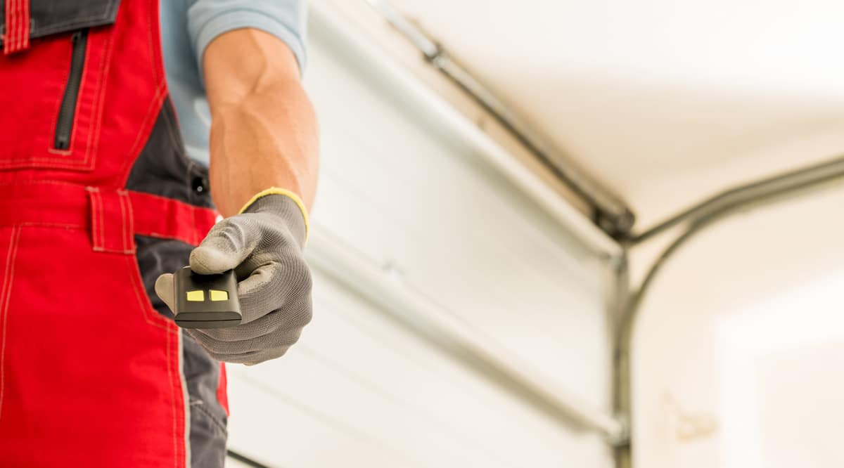 garage doors installer finishing his work and deliver door remot