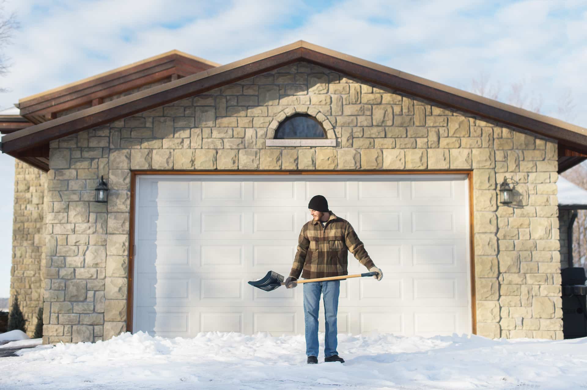 man shoveling snow, young's point, ontario, canada