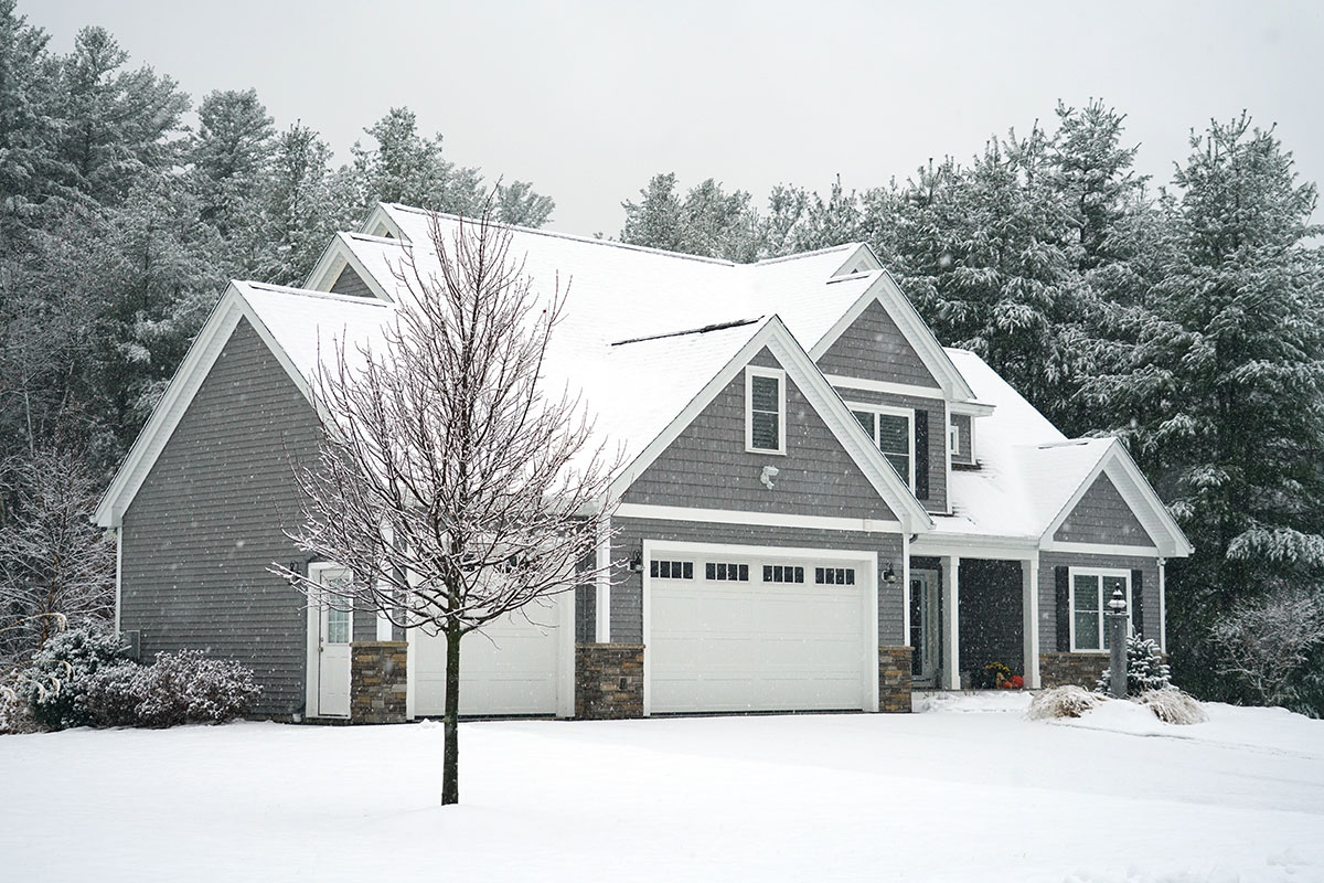 Winter house with woods in snow storm